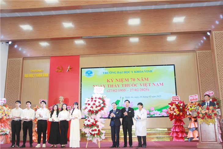 Đại diện lãnh đạo nhà trường và bệnh viện trường nhận hoa chúc mừng từ tập thể sinh viên trao tặng